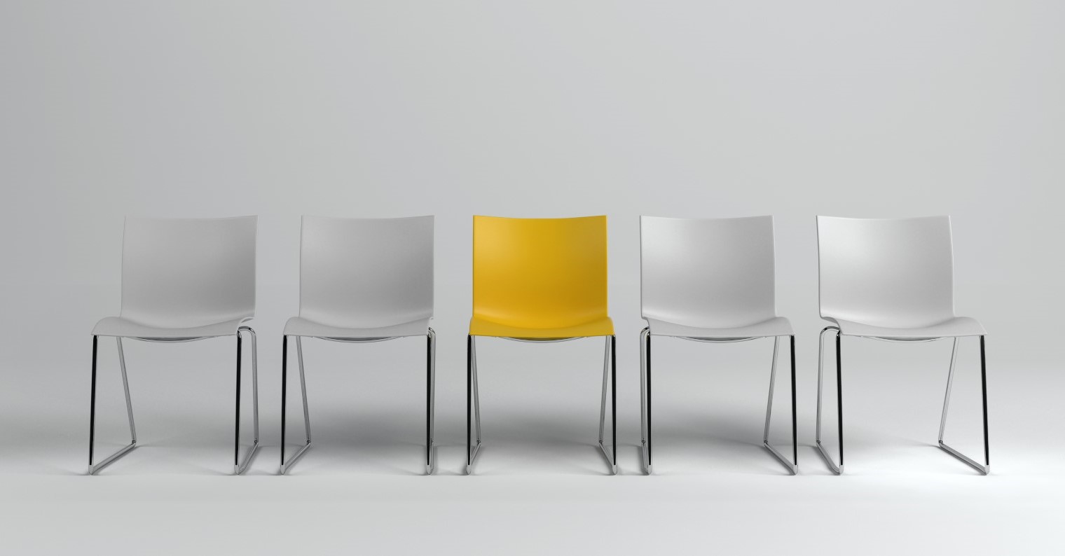 Row of empty white chairs with a distinctive yellow one in the middle, representing a standout choice in a business setting.